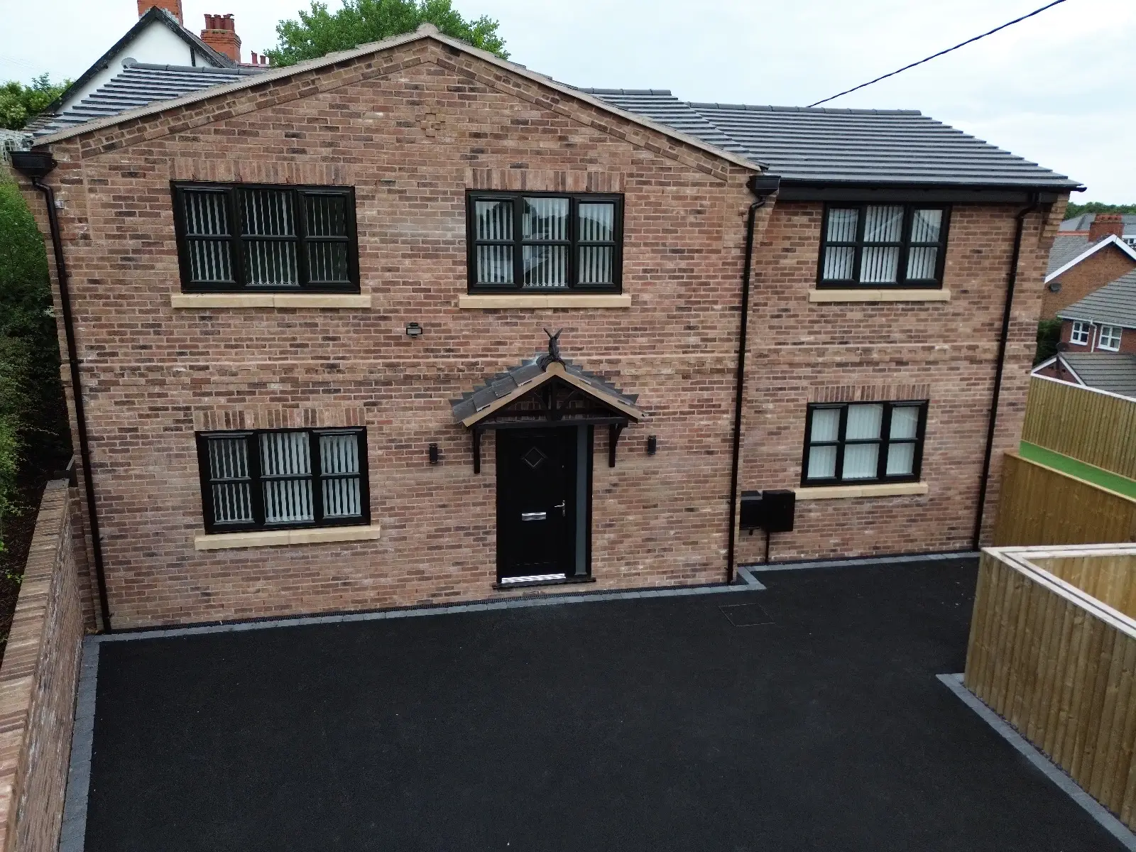 image of a house with newly fitted grey black upvc windows