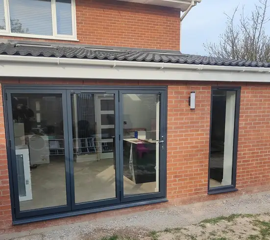 image of black aluminium new bifold doors fitted to a home in Broughton near Chester