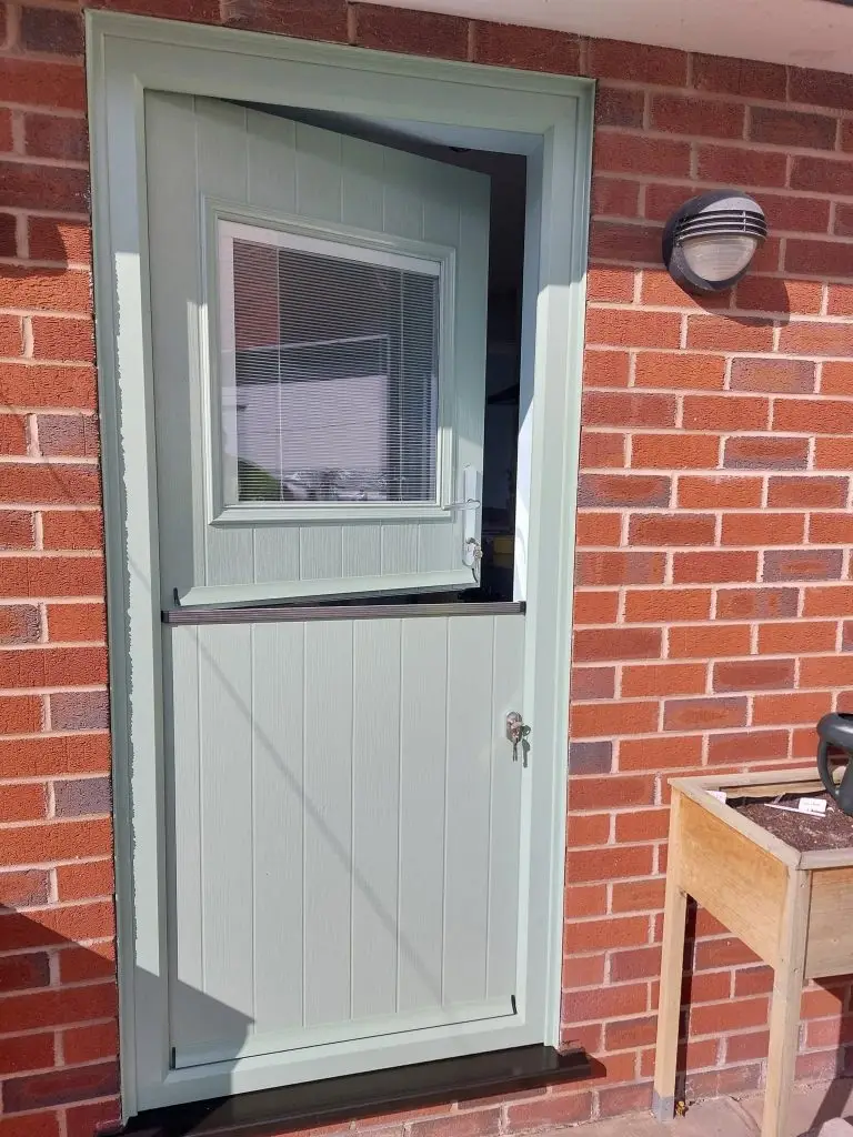 image of a country cottage style front door in green that has the top half open