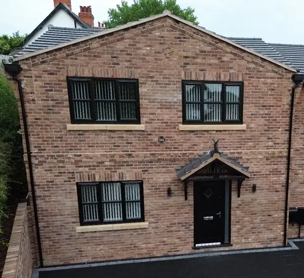 image of a house with newly installed black framed windows